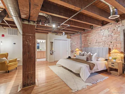 a bed room with a bed and a wooden floor
