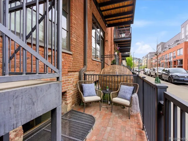 a balcony with furniture and a potted plant
