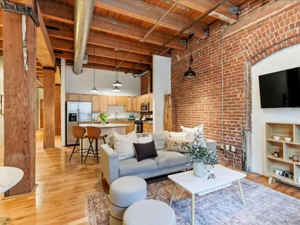 a living room with fireplace furniture and a flat screen tv