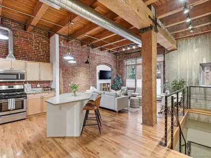 a view of a dining room with furniture wooden floor and a chandelier