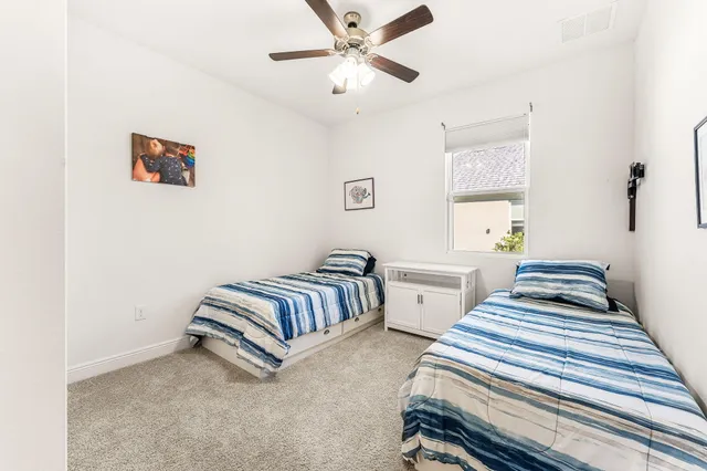 a view of a house with a big yard and large trees