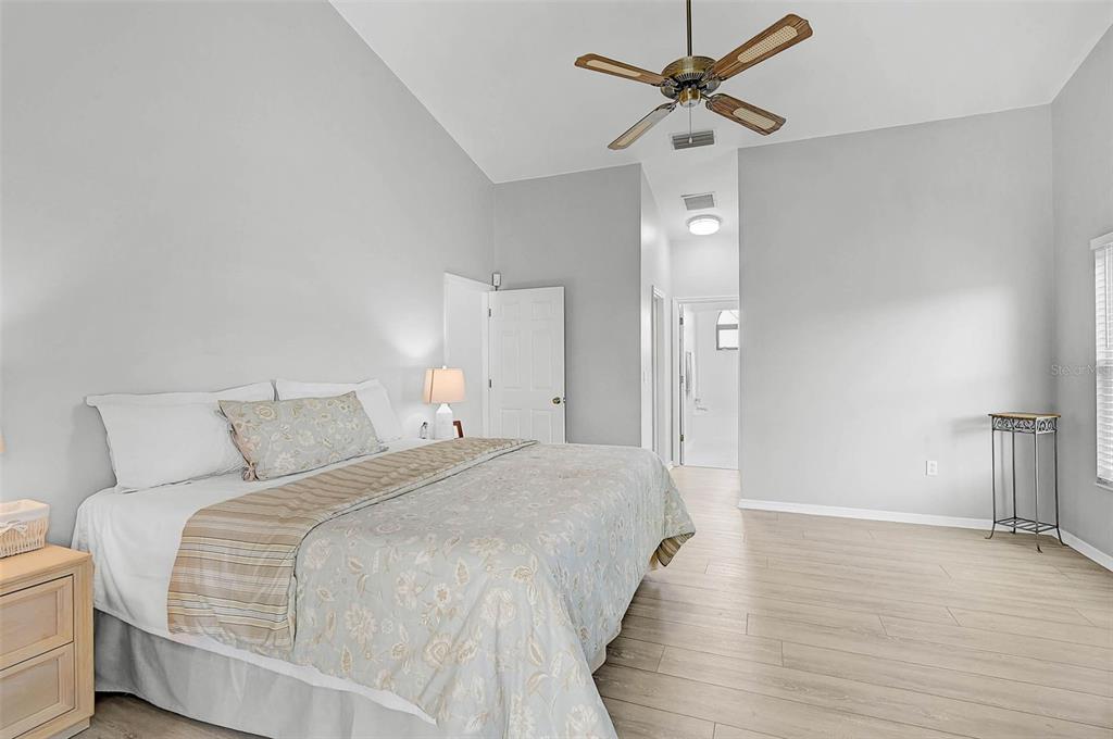 4312 Pro Am Avenue East Bradenton, FL 34203 - Photo 14 of 37 a bedroom with a bed and a chandelier