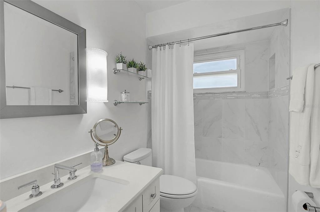 4312 Pro Am Avenue East Bradenton, FL 34203 - Photo 18 of 37 a bathroom with a sink a toilet and shower