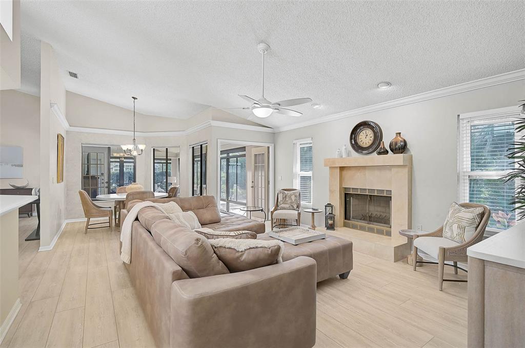4312 Pro Am Avenue East Bradenton, FL 34203 - Photo 25 of 37 a living room with furniture a clock and a fireplace