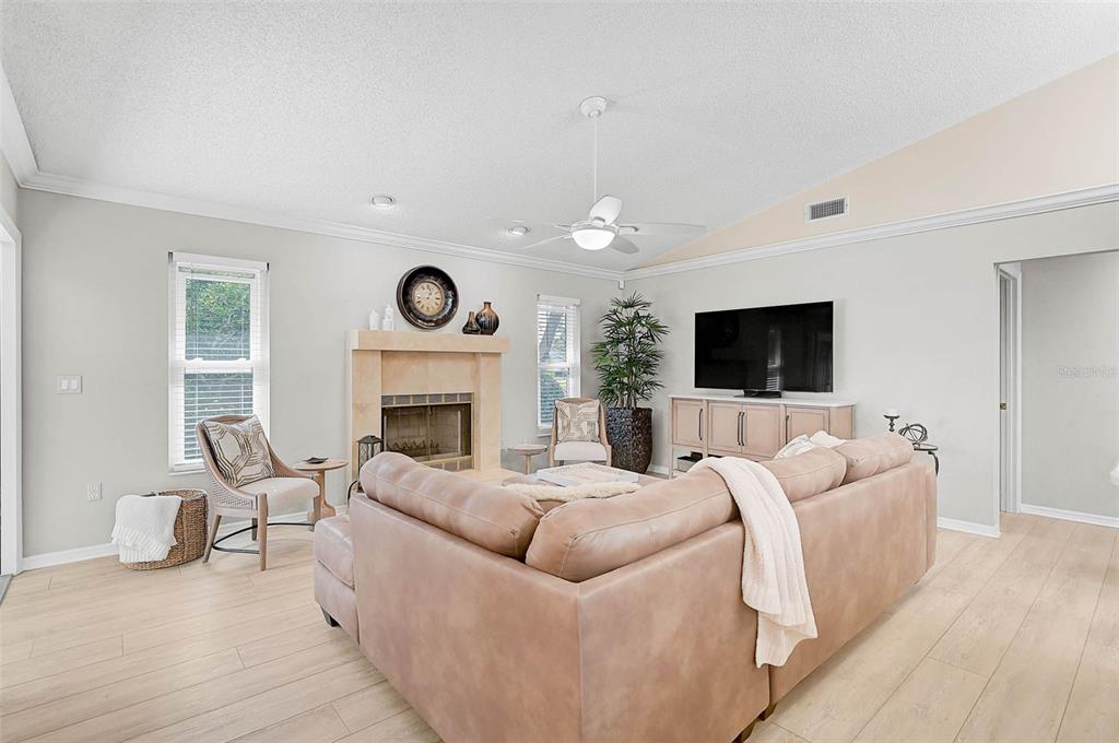 4312 Pro Am Avenue East Bradenton, FL 34203 - Photo 27 of 37 a living room with furniture a flat screen tv and a fireplace