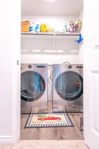 a large kitchen with stainless steel appliances granite countertop a lot of counter space and wooden floors