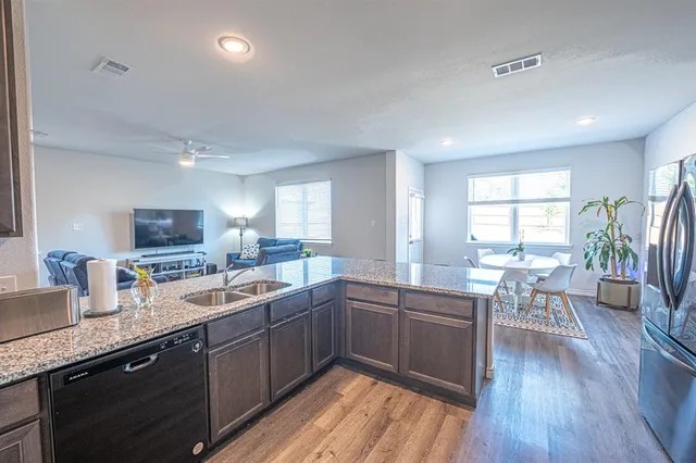a kitchen with lots of counter top space and sink