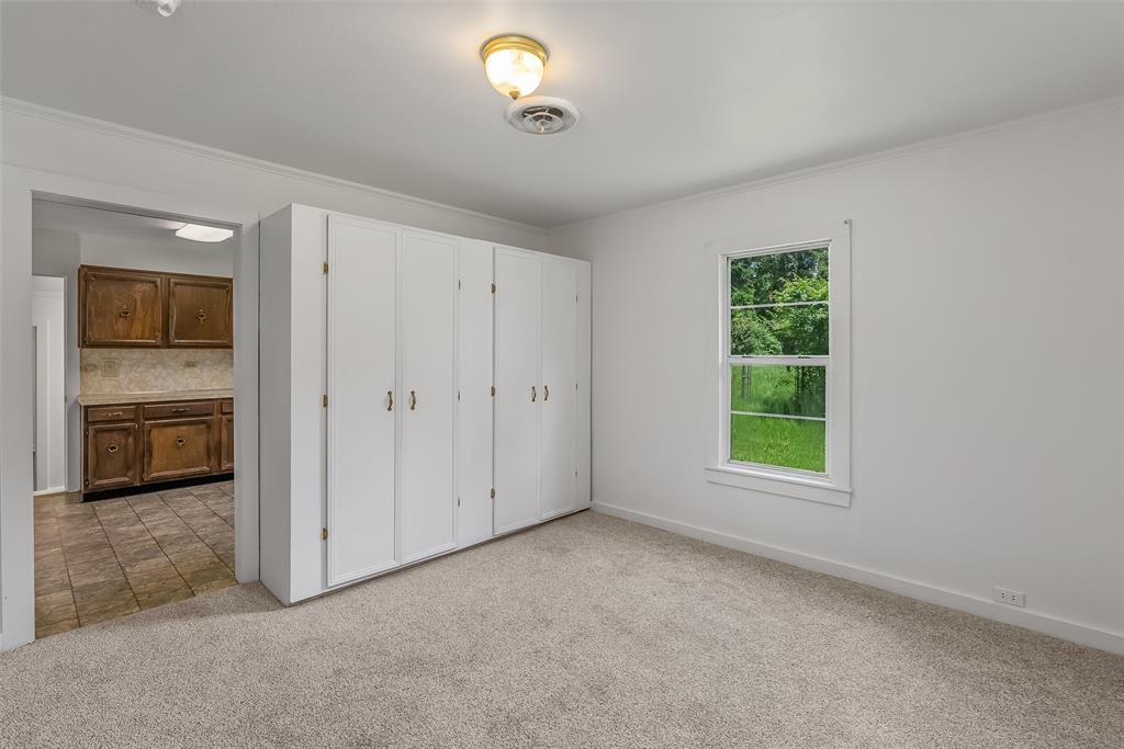 9008 Hosston Vivian Road Vivian, LA 71082 - Photo 11 of 30 an empty room with windows and cabinet