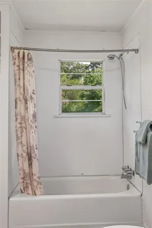 a bathroom with a bathtub and a shower