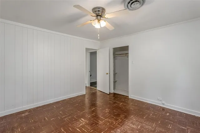a view of a room with a chandelier fan and a window