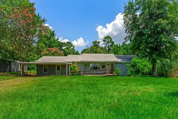 a view of a house with a yard porch and sitting area