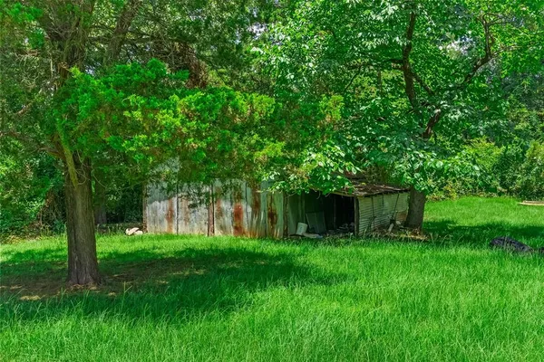 a view of front of a house with a big yard