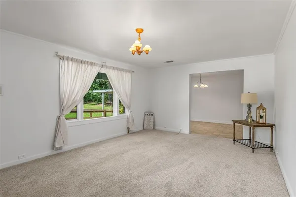 an empty room with a window and a fireplace