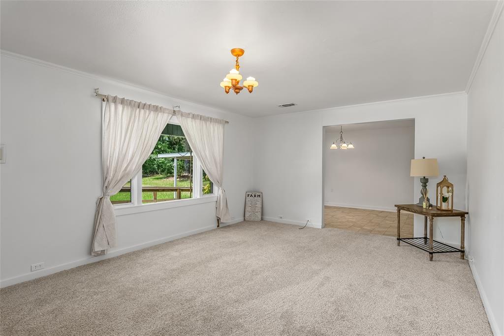 9008 Hosston Vivian Road Vivian, LA 71082 - Photo 3 of 30 an empty room with a window and a fireplace