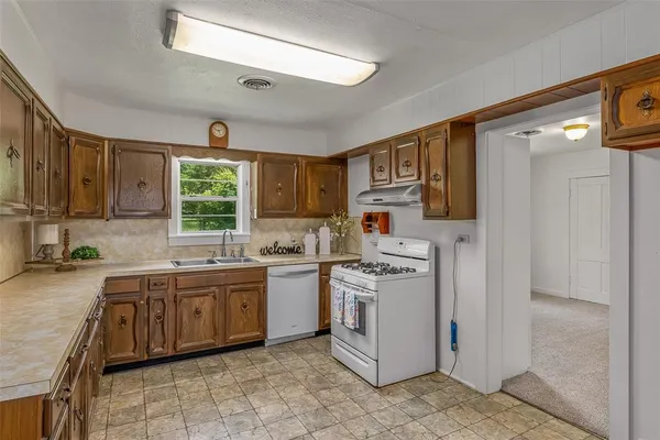 a kitchen with a sink stove and cabinets
