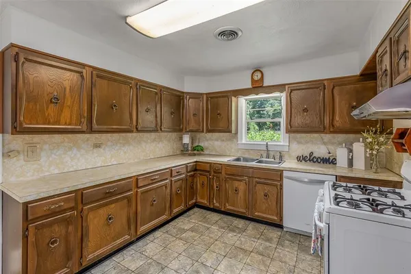 a kitchen with stainless steel appliances granite countertop a sink and cabinets