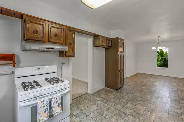 a kitchen with a stove and a refrigerator