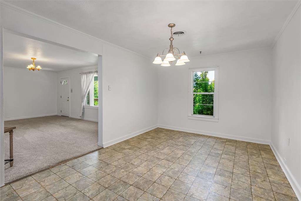 9008 Hosston Vivian Road Vivian, LA 71082 - Photo 9 of 30 an empty room with windows and chandelier