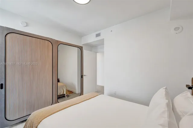 a bedroom with a bed and a television