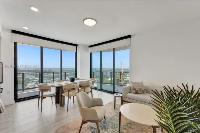 a living room with furniture a window and a kitchen view