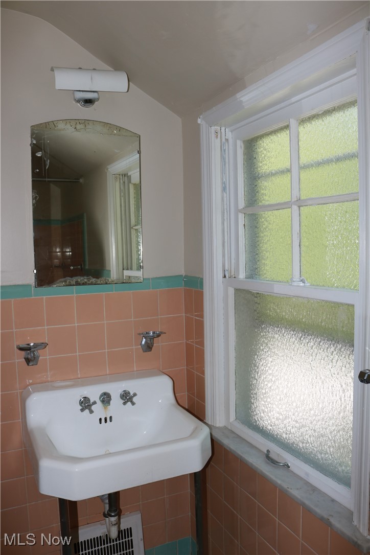 5095 Edenhurst Road Cleveland, OH 44124 - Photo 8 of 9 Bathroom featuring tile walls and a healthy amount of sunlight