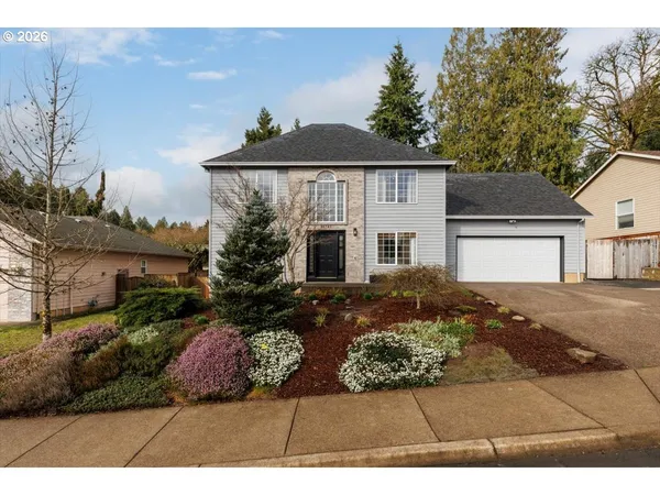 a front view of a house with a yard and garage