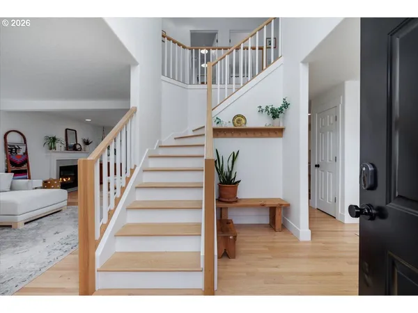 a view of entryway and hall with wooden floor