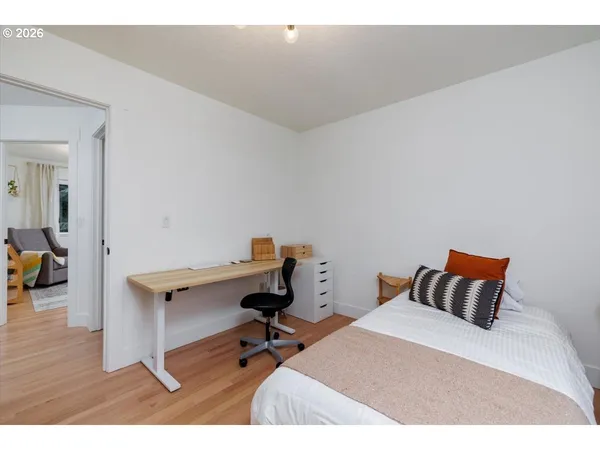 a bed room with a bed and a chair