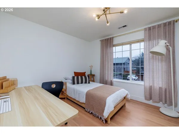a bedroom with a bed and window