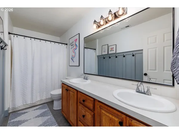 a bathroom with a sink double vanity and a mirror