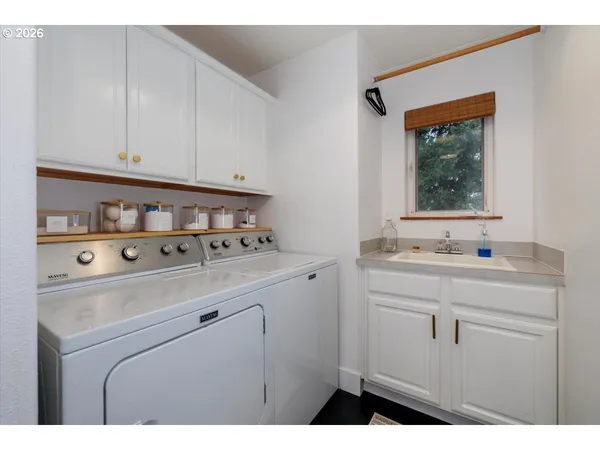a kitchen with a sink cabinets and a window