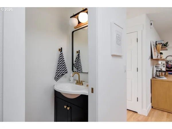 a bathroom with a sink vanity and a mirror