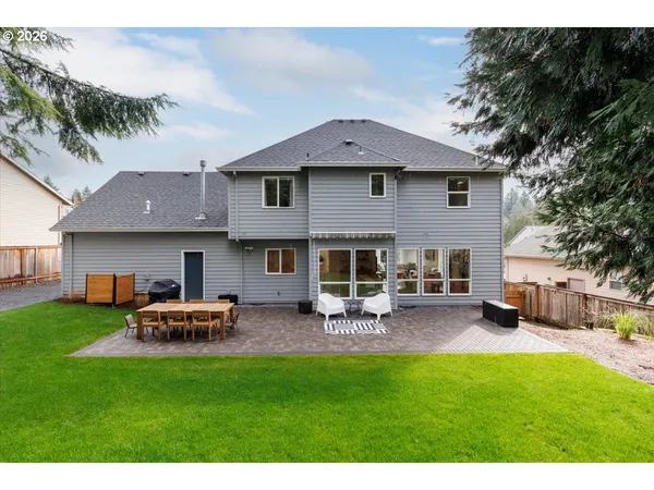 a front view of a house with patio and garden