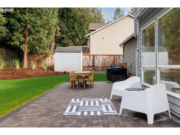 a view of a patio with table and chairs a barbeque with wooden fence