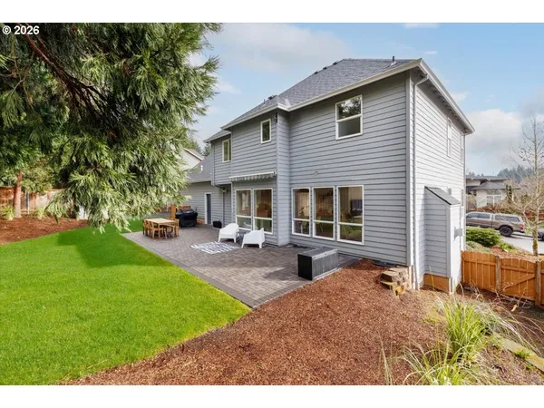a view of a house with a yard and garage