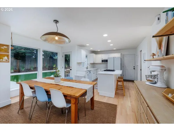 a view of a dining room with furniture and wooden floor