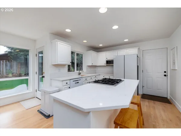 a kitchen with a sink a stove a refrigerator and a oven