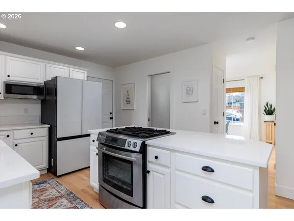 a kitchen with a stove a refrigerator and a sink