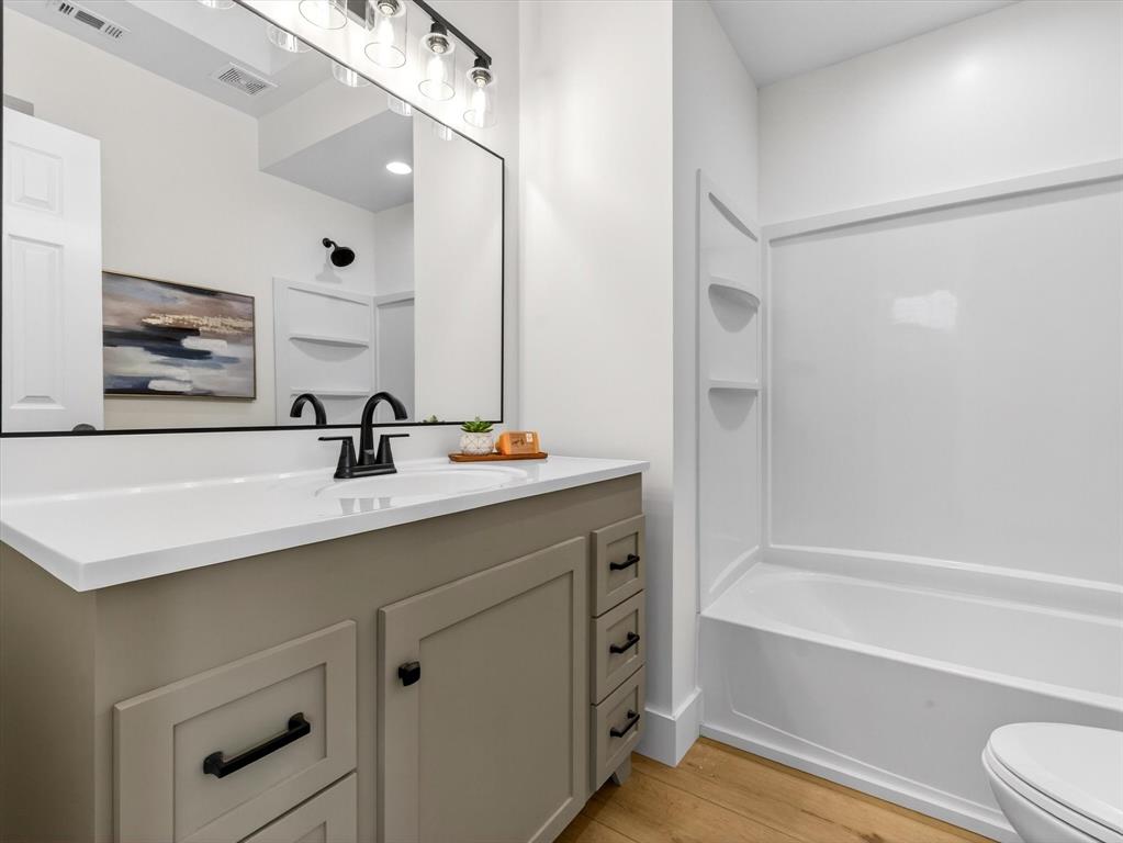 4345 Timberglen Road Dallas, TX 75287 - Photo 13 of 26 a bathroom with a sink a toilet and shower