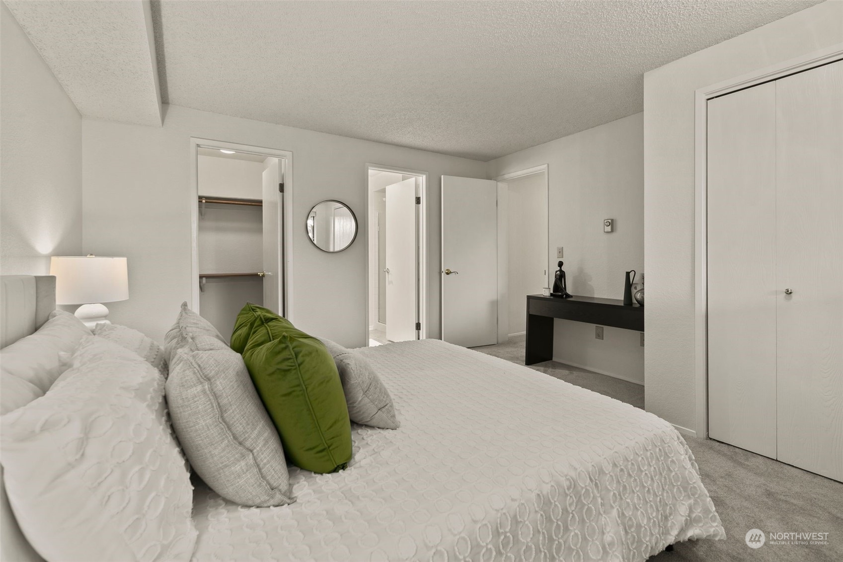 1633 Eagle Ridge Drive South, Unit A5 Renton, WA 98055 - Photo 13 of 25 a bedroom with a bed and a lamp