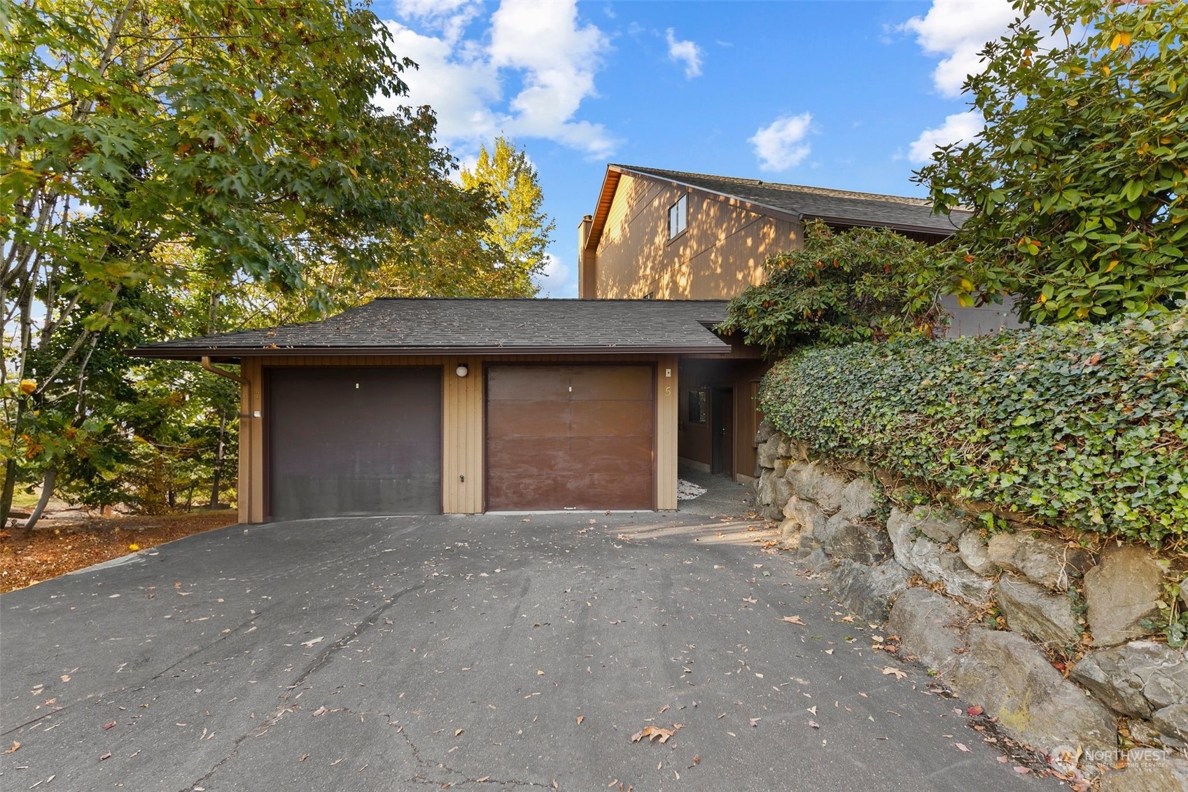 1633 Eagle Ridge Drive South, Unit A5 Renton, WA 98055 - Photo 18 of 25 a front view of a house with a yard and garage