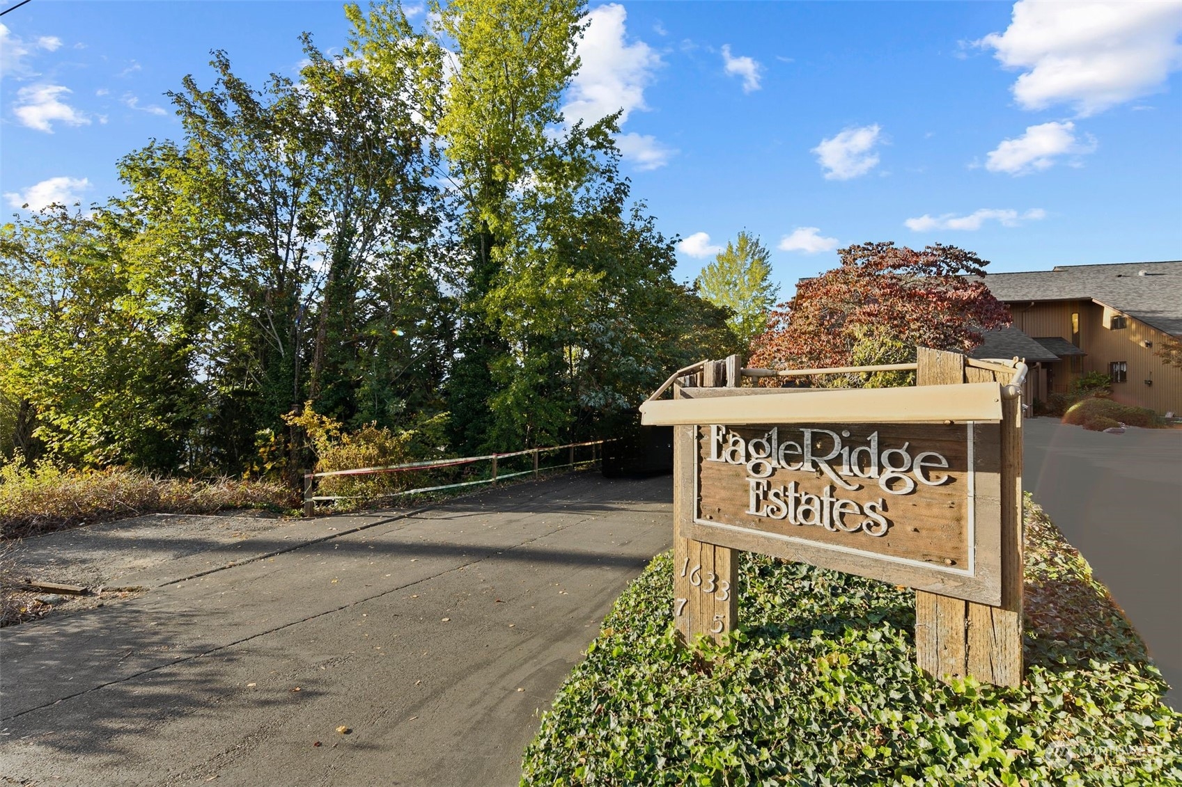 1633 Eagle Ridge Drive South, Unit A5 Renton, WA 98055 - Photo 20 of 25 a view of a street with sign on the side of the road