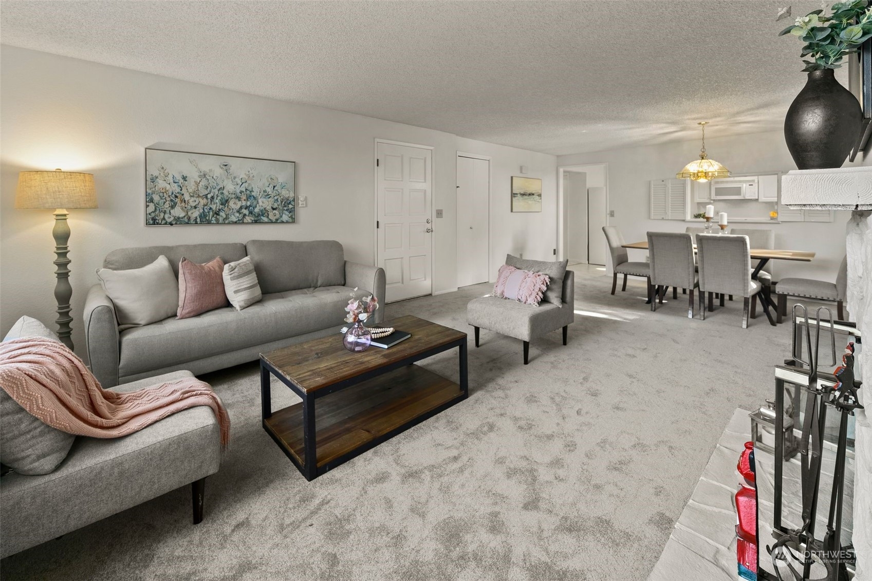 1633 Eagle Ridge Drive South, Unit A5 Renton, WA 98055 - Photo 5 of 25 a living room with furniture a fireplace and many windows