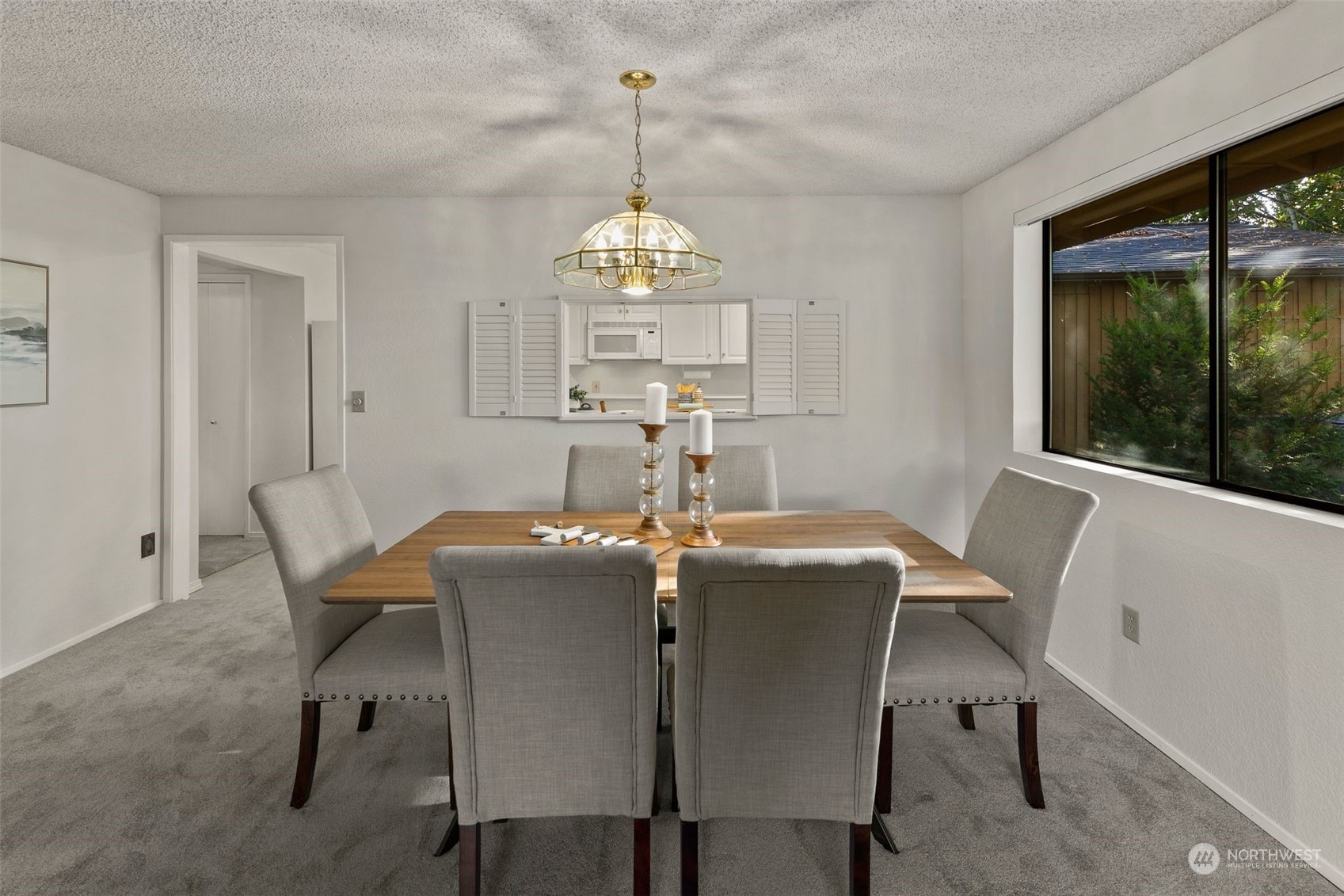 1633 Eagle Ridge Drive South, Unit A5 Renton, WA 98055 - Photo 6 of 25 a dining room with furniture a chandelier and window