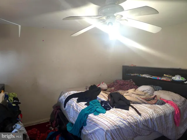 a bed sitting in a bedroom next to a lamp