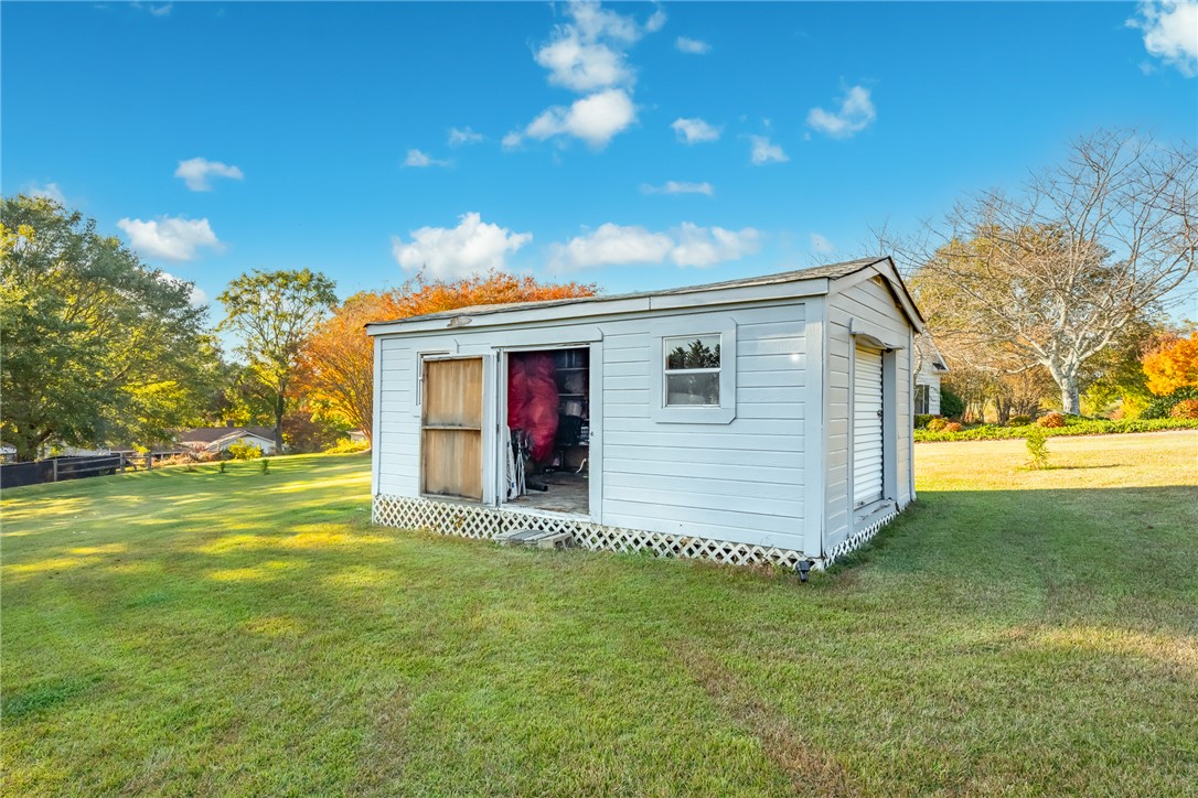 401 South Glassy Mountain Road Pickens, SC 29671 - Photo 28 of 37 This outdoor shed provides ample storage within a spacious, grassy yard.
