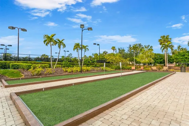 a view of a chair and table in backyard of the house
