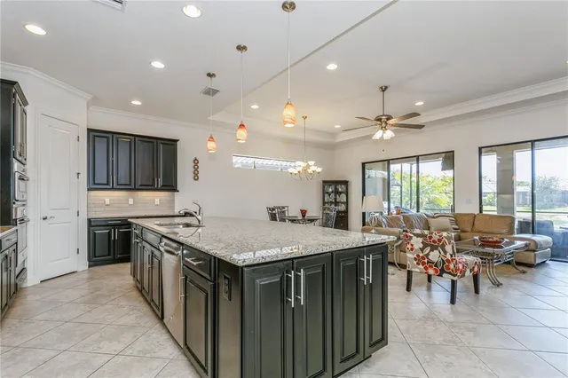 a kitchen with stainless steel appliances granite countertop a stove and a sink