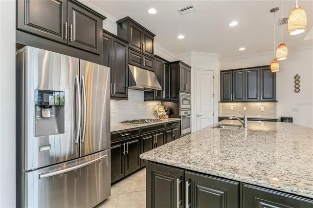 a view of a dining room with furniture and a chandelier
