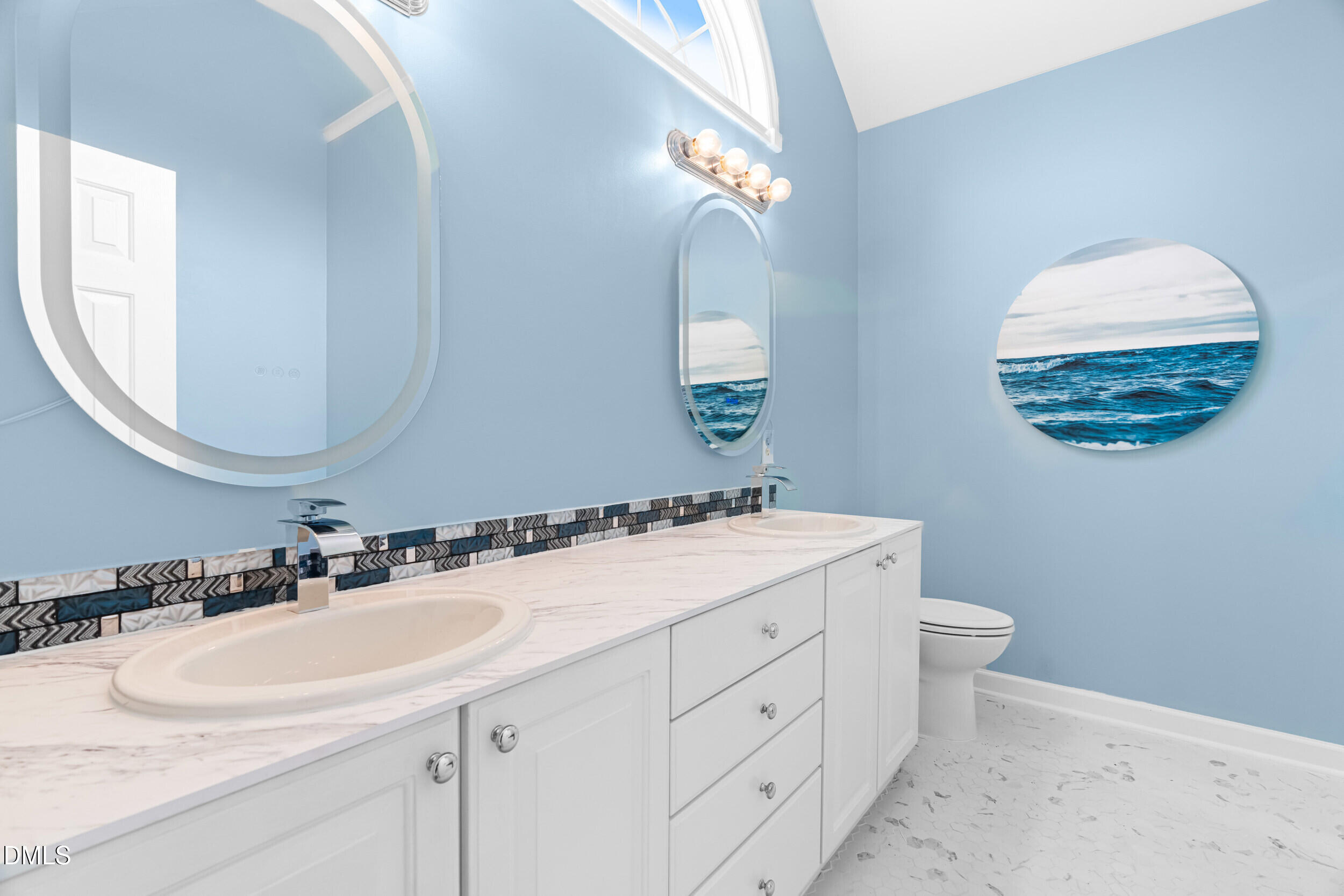 744 Seastone Street Raleigh, NC 27603 - Photo 30 of 53 a bathroom with a sink and a mirror